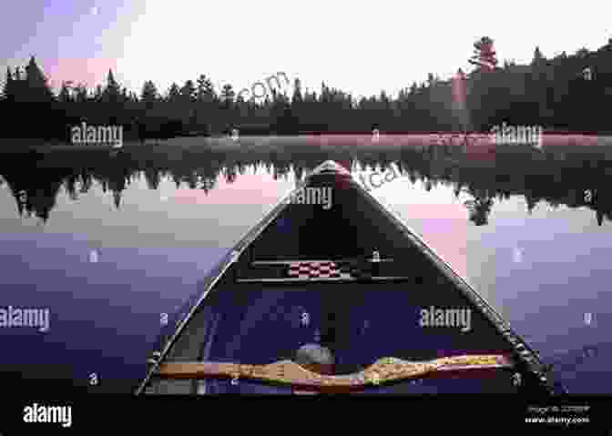 Canoe Gliding Through A Picturesque Lake In The Canadian Wilderness, Surrounded By Towering Trees And Serene Waters. By Canoe And Dog Train: The Adventures Of Sharing The Gospel With Canadian Indians (Updated Edition Includes Original Illustrations )